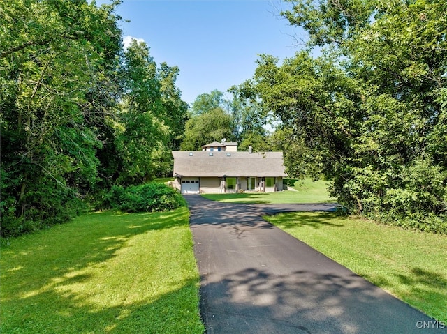 view of front of property featuring a garage and a front lawn