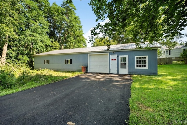 single story home with a garage and a front lawn