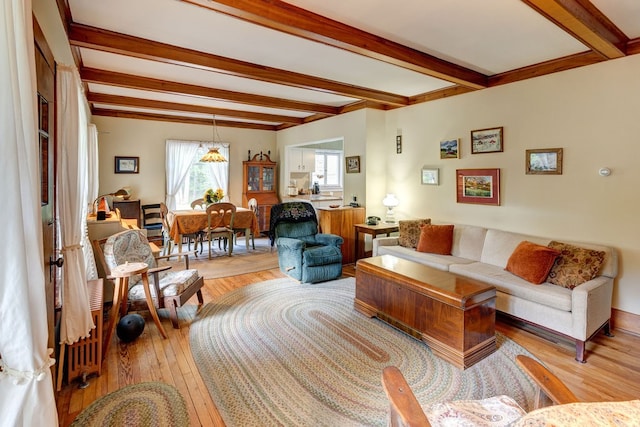 living room with light wood-type flooring and beamed ceiling