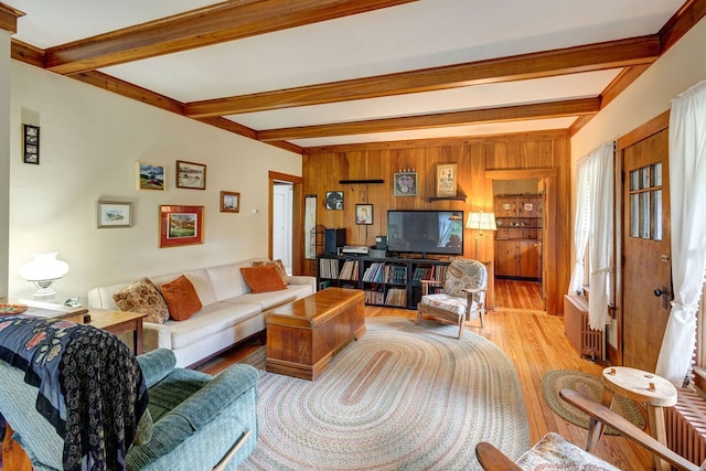 living room with beamed ceiling and light hardwood / wood-style floors