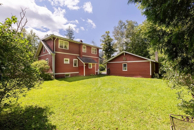 rear view of property featuring a yard