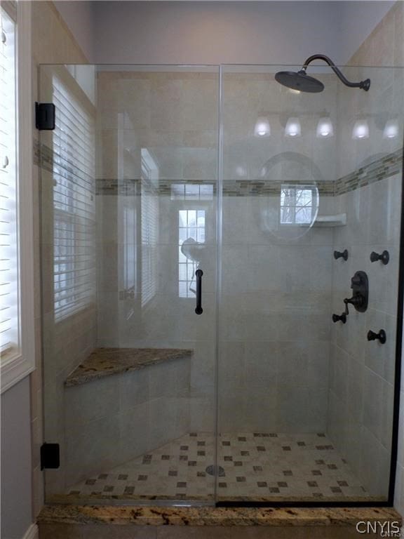 bathroom with a shower with shower door