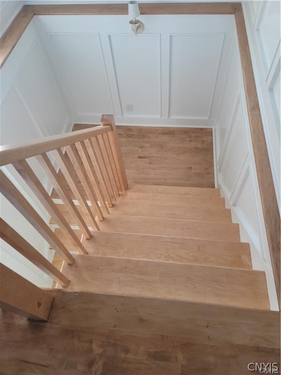 staircase with hardwood / wood-style flooring