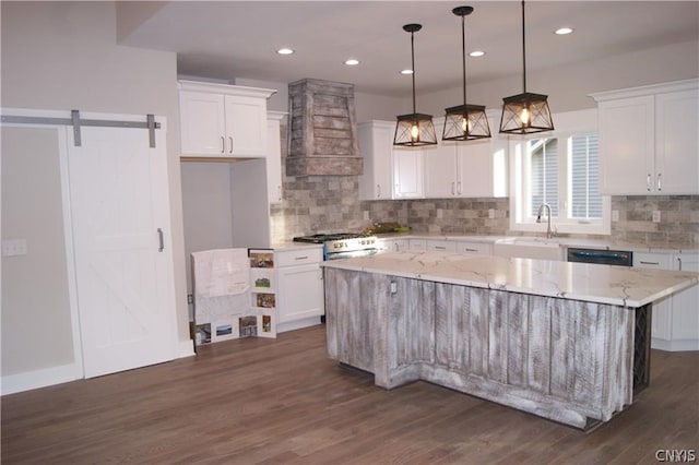 kitchen featuring white cabinetry, dark wood-type flooring, custom exhaust hood, and a kitchen island