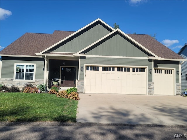 craftsman house featuring a garage, a porch, and a front yard