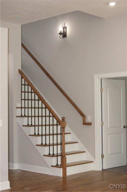 stairway featuring hardwood / wood-style flooring