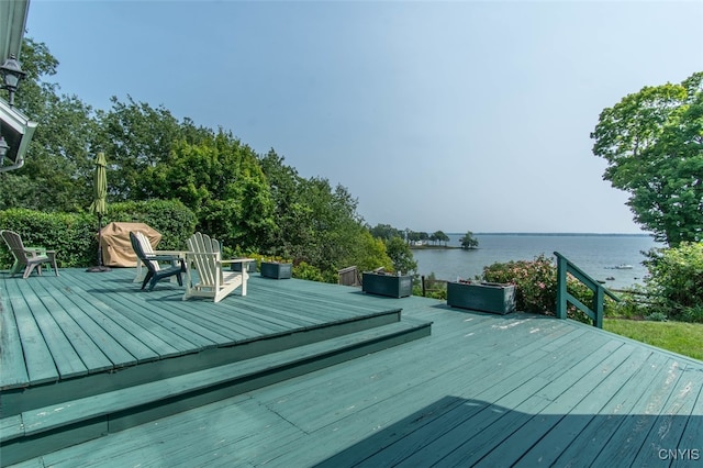 wooden deck featuring a water view