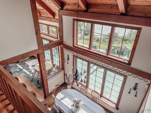 living room with a wealth of natural light, hardwood / wood-style floors, and beamed ceiling