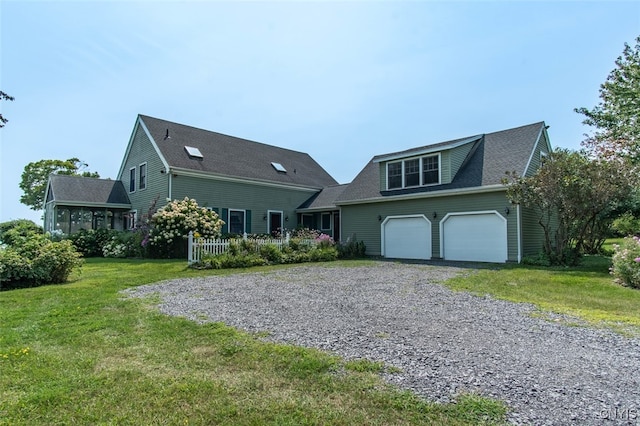 view of front of home featuring a front lawn and a garage