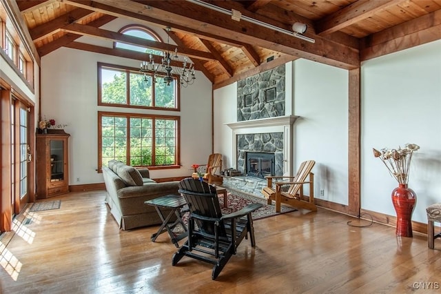 27454 County Route 57, Lyme, NY 13693 - living room with wood ceiling with exposed beams, a chandelier, a fireplace, wood-type flooring, and baseboards