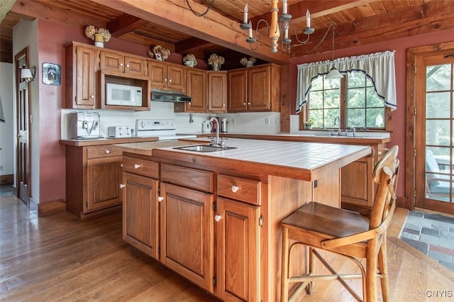 27454 County Route 57, Lyme, NY 13693 - kitchen with wood ceiling with exposed beams, tile counters, a sink, white appliances, and under cabinet range hood