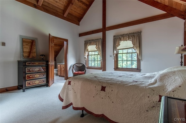 carpeted bedroom with wooden ceiling, vaulted ceiling with beams, and ensuite bath