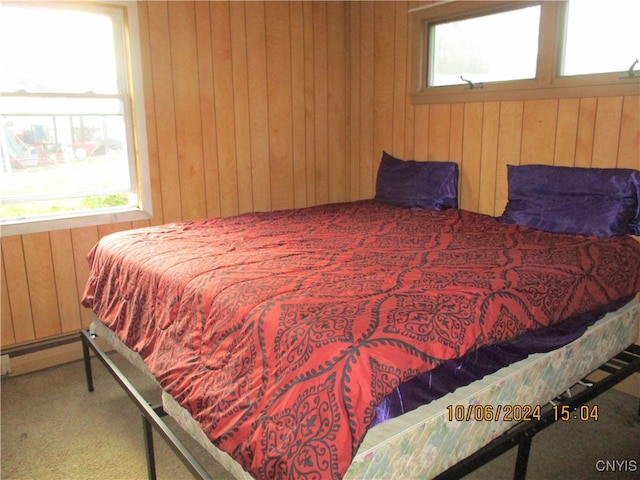 bedroom with carpet and wooden walls