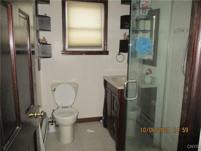 bathroom with vanity, tile patterned flooring, toilet, and a shower with door