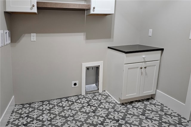 laundry room with cabinets and electric dryer hookup