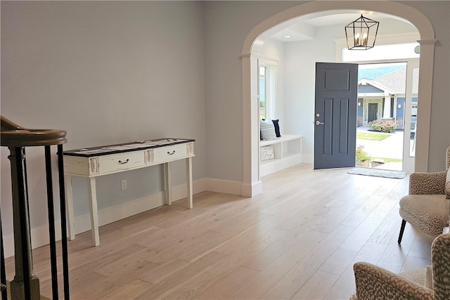 foyer with a notable chandelier and light hardwood / wood-style floors