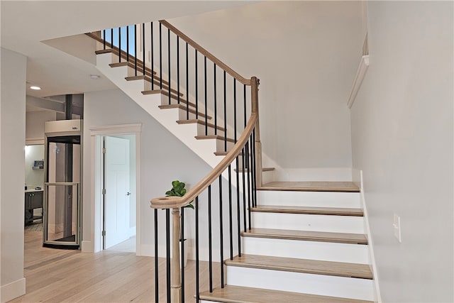 stairway with wood-type flooring