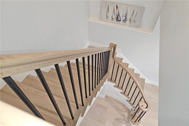 stairs with hardwood / wood-style floors