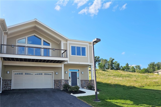 view of front of home with a front yard and a garage