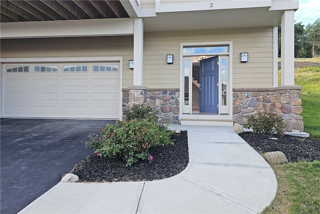 view of exterior entry with a garage