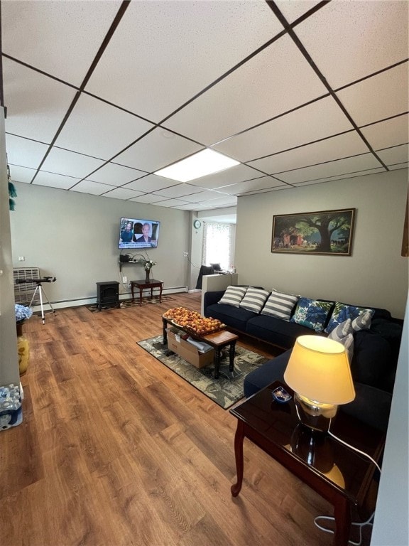 living room featuring hardwood / wood-style floors and a drop ceiling