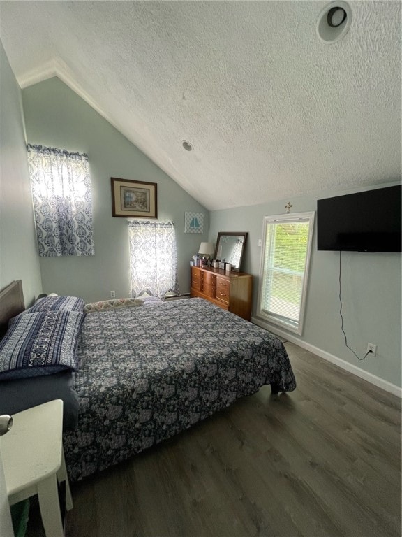 bedroom with a textured ceiling, lofted ceiling, and wood-type flooring