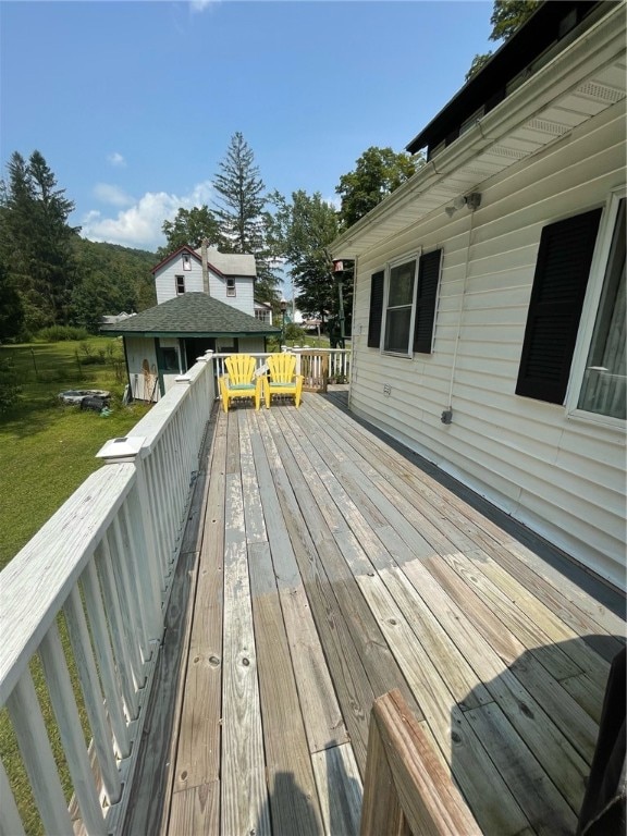 wooden deck featuring a yard