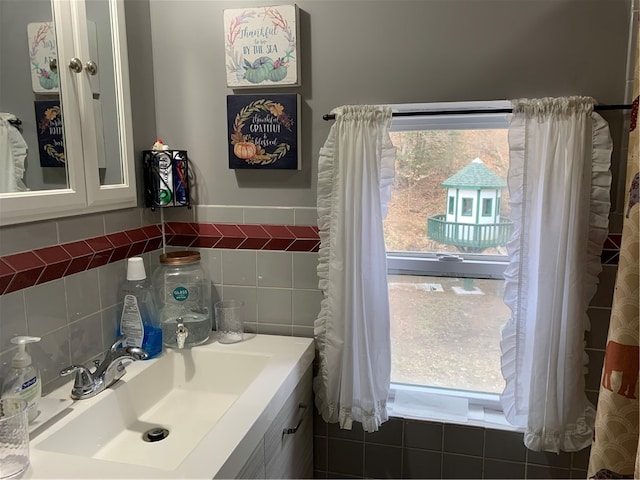 bathroom with tile walls, tasteful backsplash, and vanity