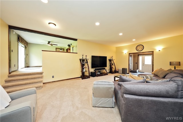 living room featuring light colored carpet and ceiling fan