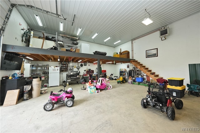 garage featuring white fridge