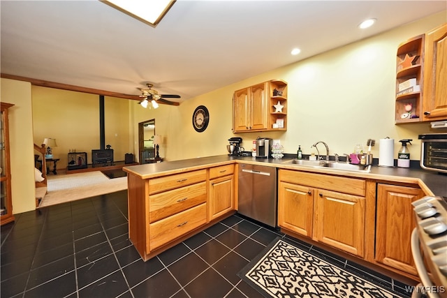 kitchen featuring ceiling fan, stainless steel dishwasher, range, dark tile patterned flooring, and kitchen peninsula