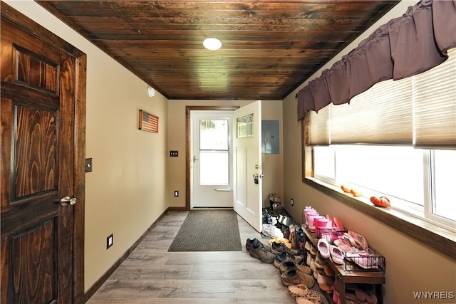 foyer with wood ceiling, electric panel, and light wood-type flooring