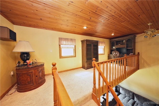 interior space with light colored carpet and wood ceiling