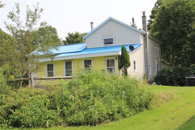 rear view of property featuring a yard