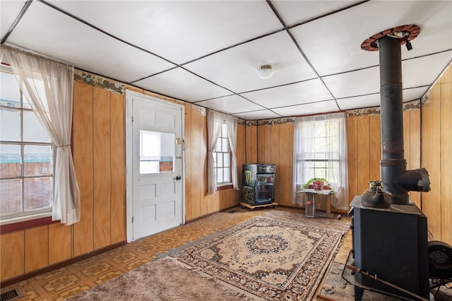 entrance foyer with parquet flooring, wooden walls, and a paneled ceiling