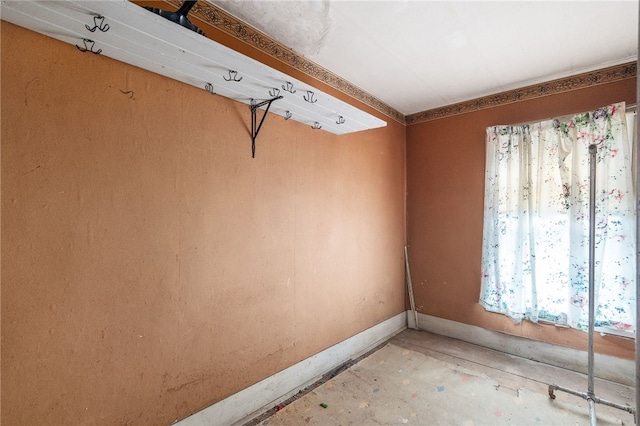 empty room featuring a wealth of natural light and concrete flooring