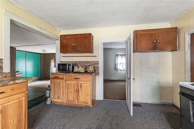 kitchen featuring electric range and dark colored carpet