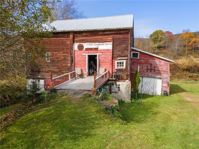 rear view of property with a lawn