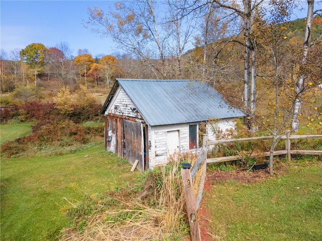 view of outbuilding featuring a lawn