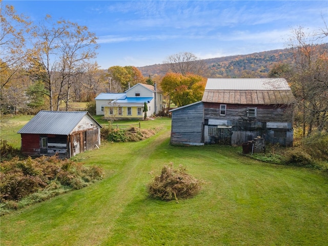 view of yard with a mountain view and an outbuilding