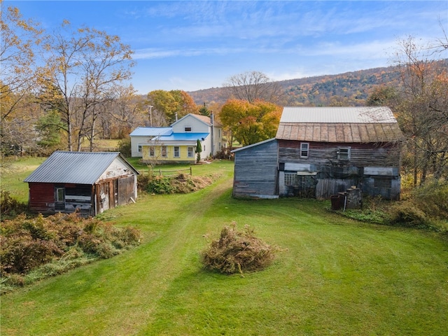 1793 County Highway 9, Davenport, NY 12197 - view of grassy yard featuring a barn, an outbuilding, and a mountain view