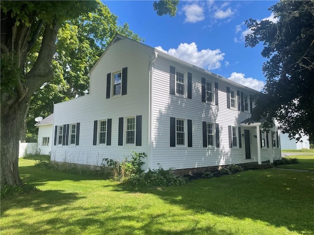 view of property exterior featuring a lawn