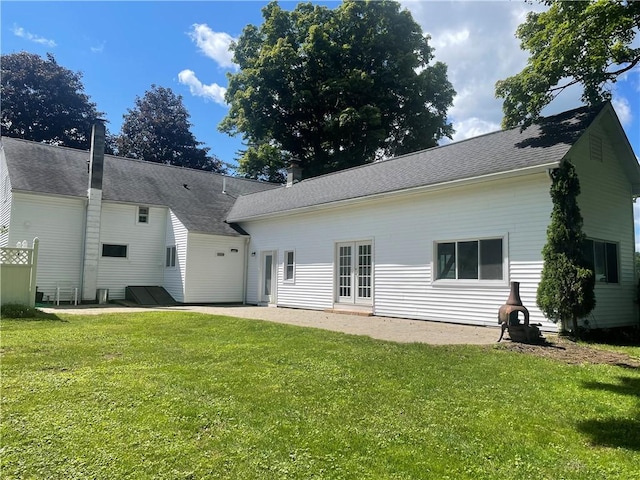 back of property with a patio and a lawn