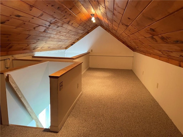 additional living space featuring lofted ceiling, light colored carpet, and wooden ceiling