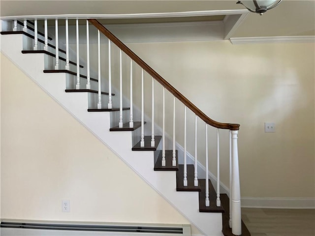 staircase with hardwood / wood-style flooring, crown molding, and baseboard heating