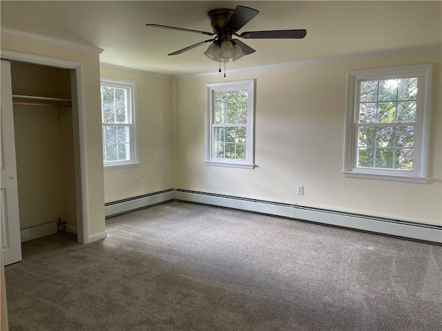 unfurnished bedroom with crown molding, carpet, ceiling fan, and a closet