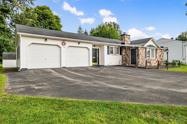 single story home featuring a garage and a front yard