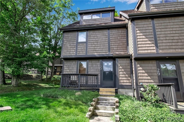 back of house with a lawn