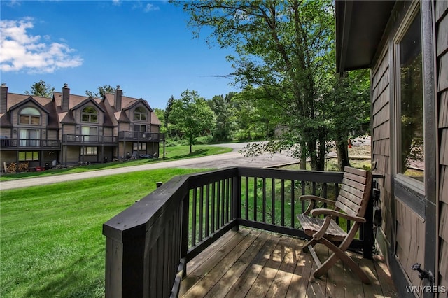 wooden terrace with a lawn