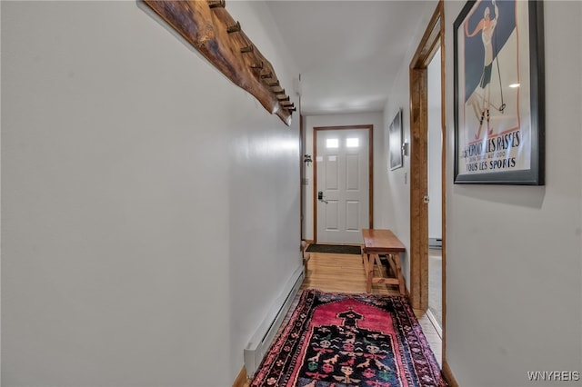 hall featuring a baseboard radiator and hardwood / wood-style flooring